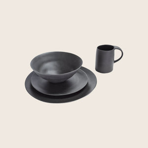 Modern black bowl with a smooth, reflective surface and minimalist design. - hover