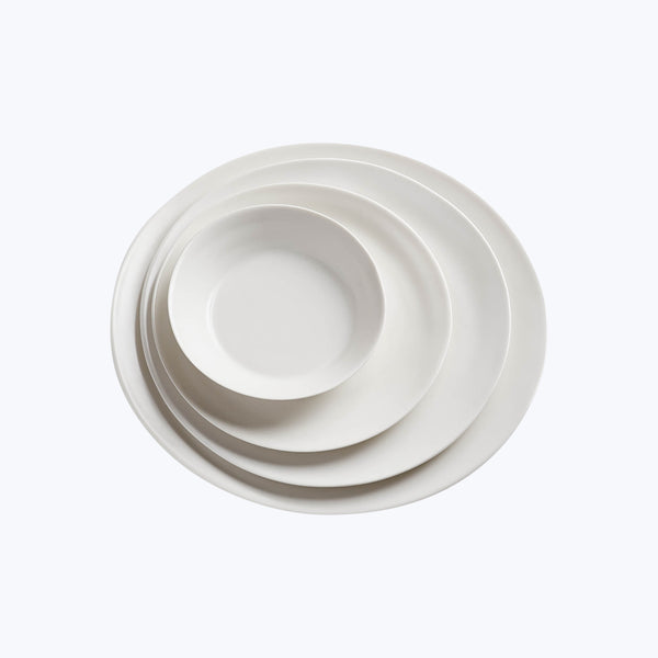 Stack of three white ceramic plates in descending sizes.