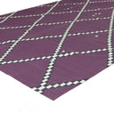 Modern purple geometric rug with white and black diamond pattern.