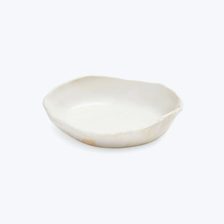 Handmade white ceramic dish with organic shape and raised edge