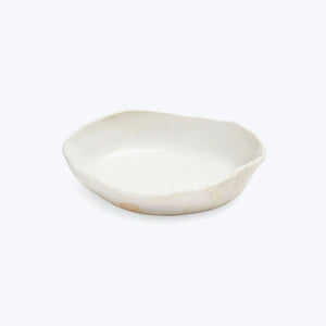 Handmade white ceramic dish with organic shape and raised edge