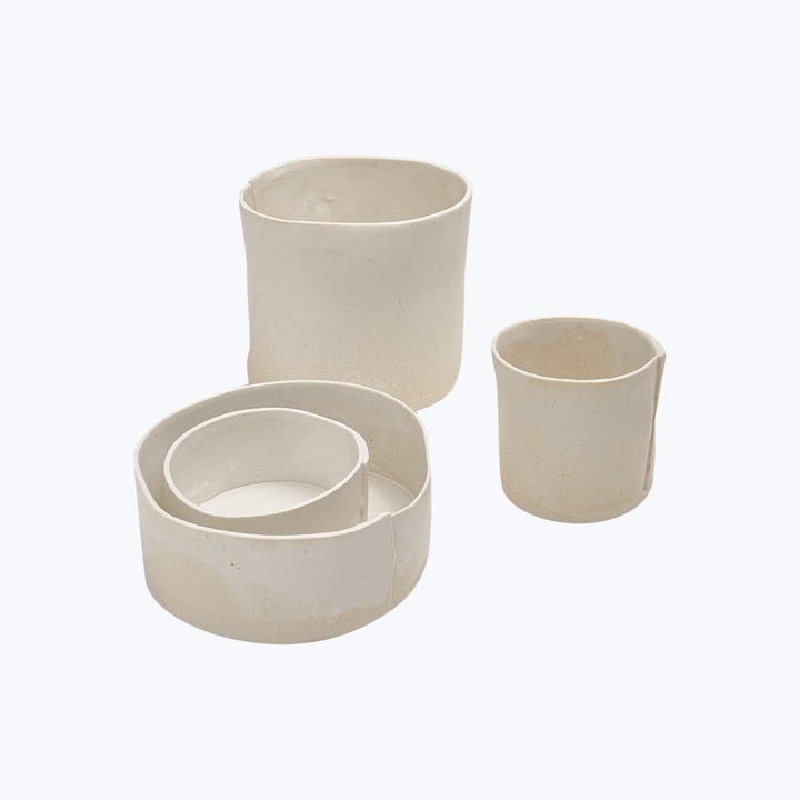 Modern ceramic objects in various sizes against white background display.