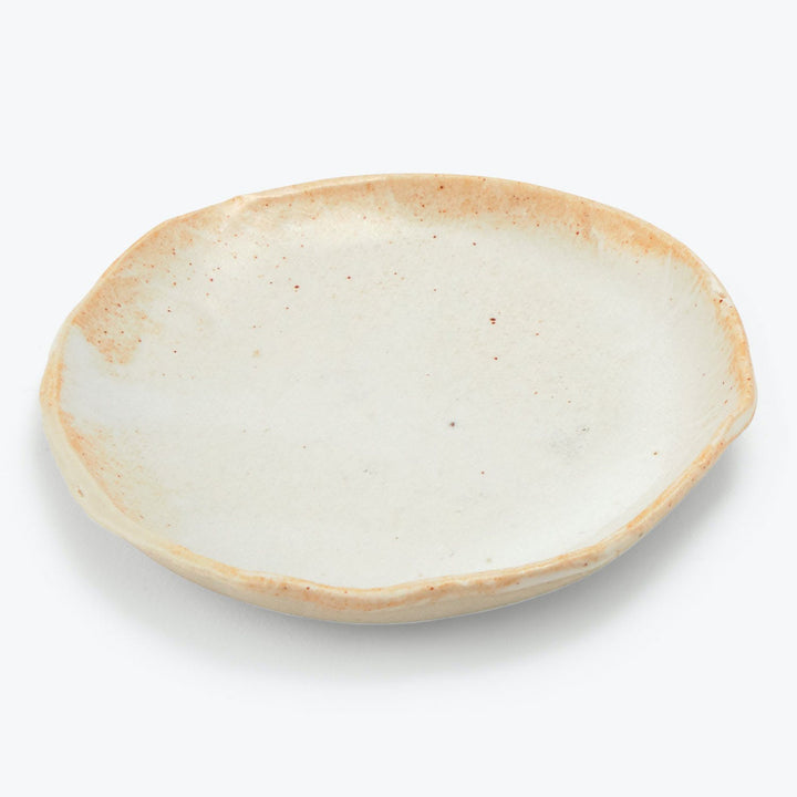 Handmade oval ceramic plate with cream color and brown speckles.