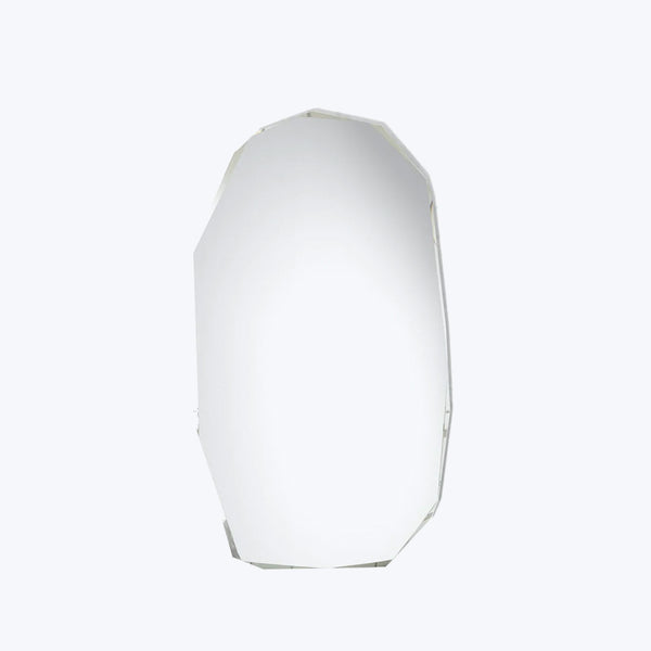 Minimalist geometric object with reflective surface against plain white background.