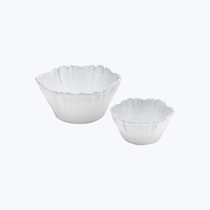 Handcrafted ceramic bowls with fluted edges on white background