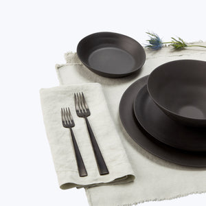 Minimalistic black bowl with matte finish on white background. - hover