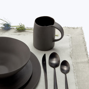 Minimalist black bowl with matte finish on white background. - hover