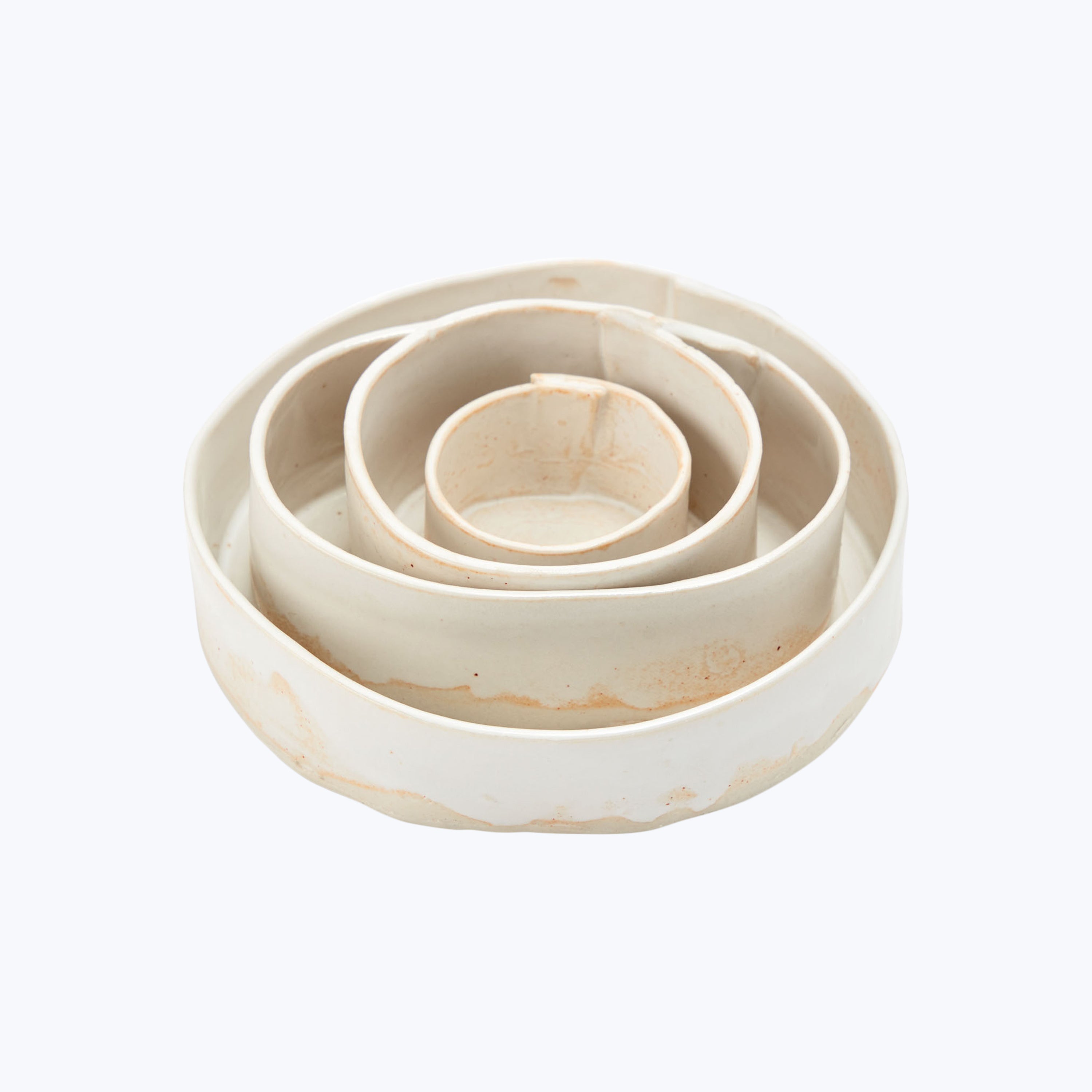 Nesting ceramic bowls in varying sizes for convenient storage.