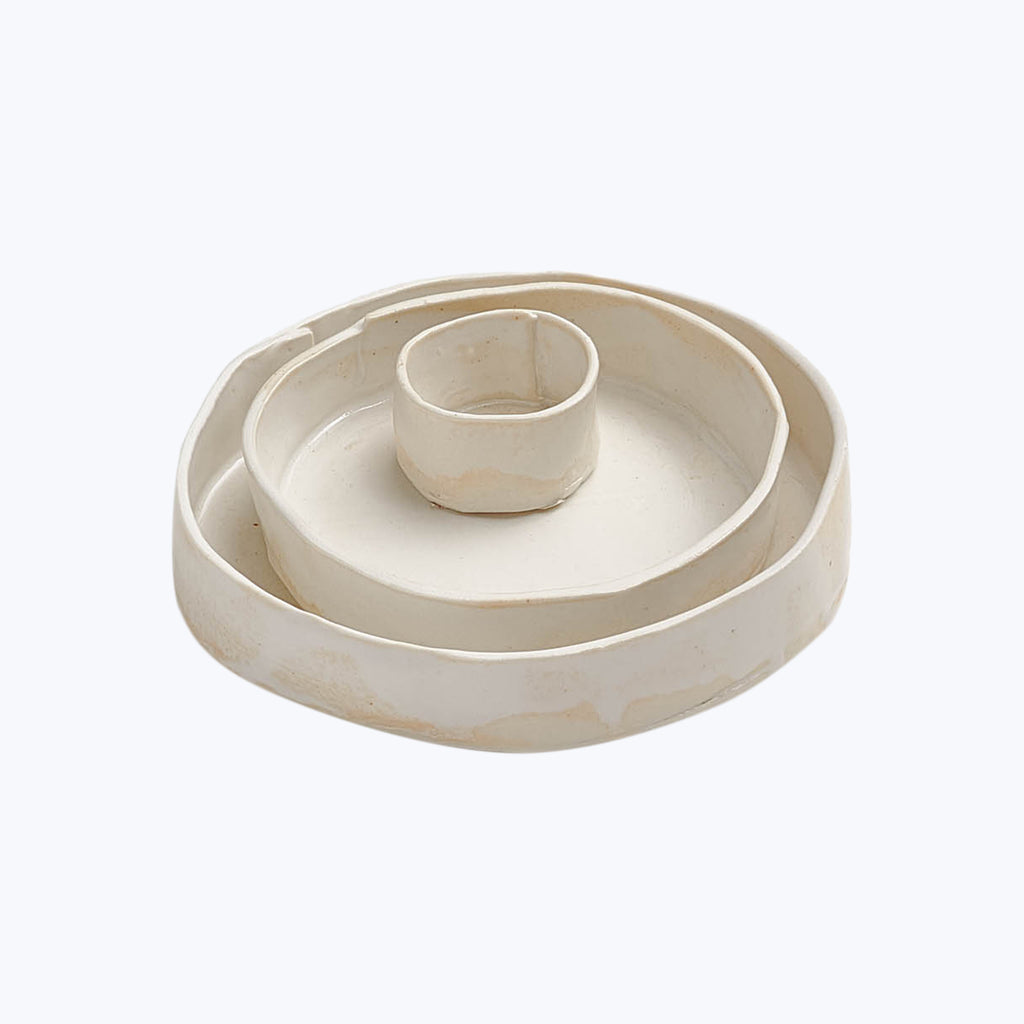 Circular ceramic ashtray with center holder for snuffing cigarettes. Discolored.