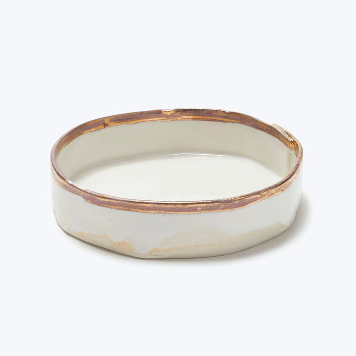 Handcrafted ceramic bowl with cream glaze and brown rim detail.