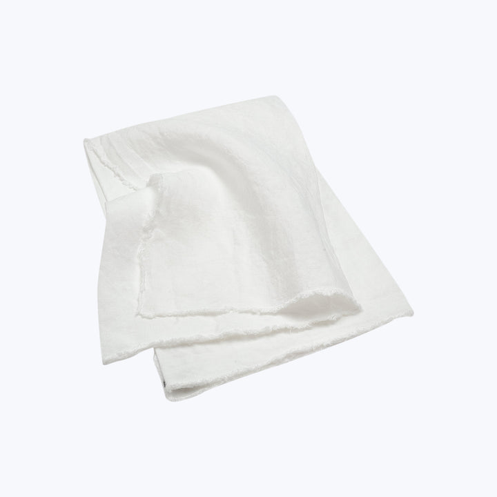 White fabric with subtle texture and frayed edges on display.