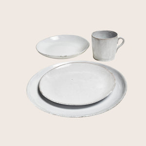 Handmade round ceramic plate with rustic design on white background. - hover
