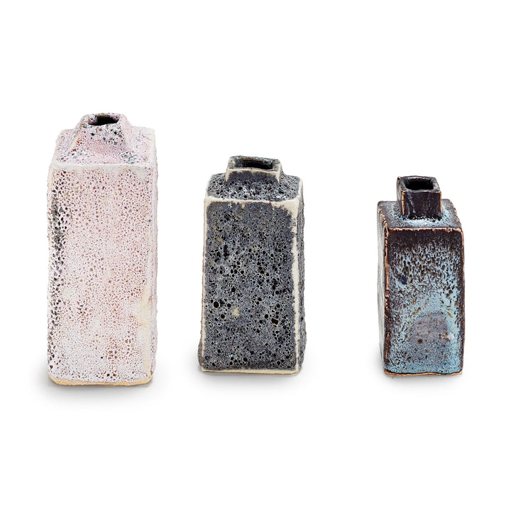 Three handmade ceramic vases with unique textures and glazes.