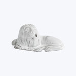 Melted white candle in form of bust head, distorted by heat.