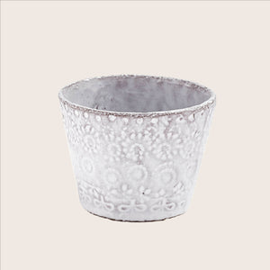 Handcrafted ceramic pot with textured design against white background. - hover