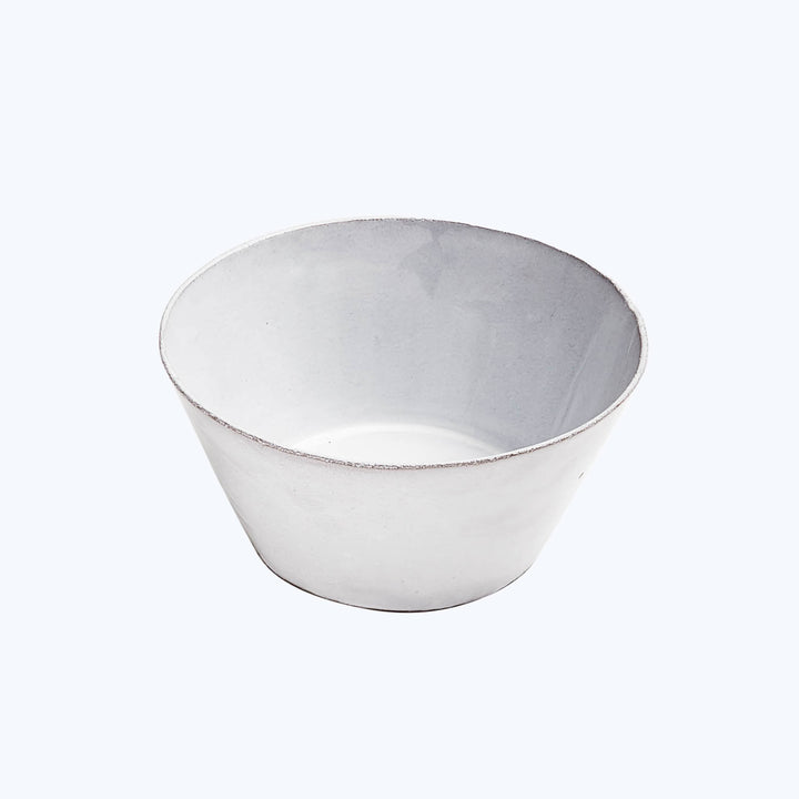 Minimalist white bowl with worn edges on isolated background surface.
