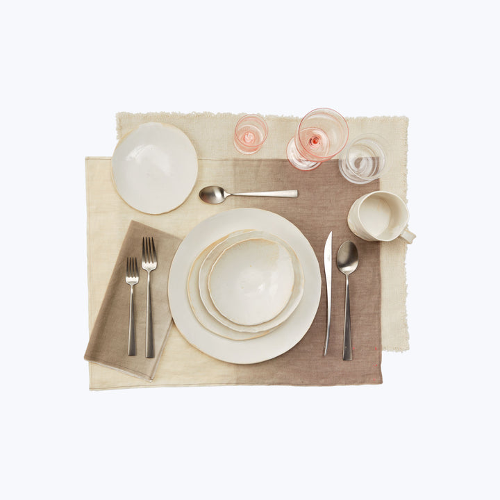 Neatly arranged table setting for one person with elegant dinnerware.