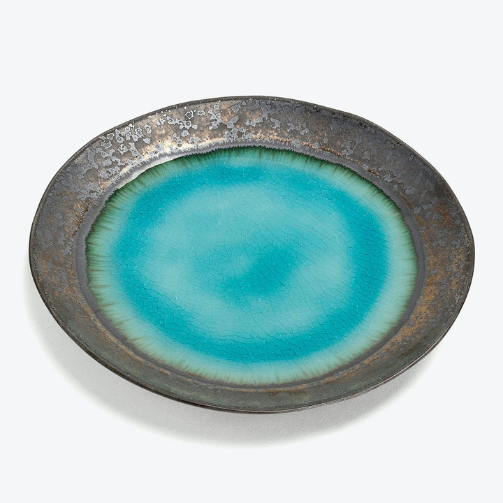 Oval ceramic plate with dark rustic rim, vibrant turquoise center