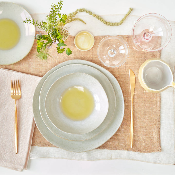 Elegantly minimalistic table setting with neutral tones and natural textures.