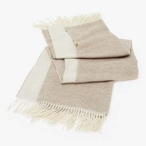 Cozy throw blanket and pillow set in natural tones and textures.