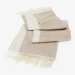 Cozy throw blanket and pillow set in natural tones and textures.