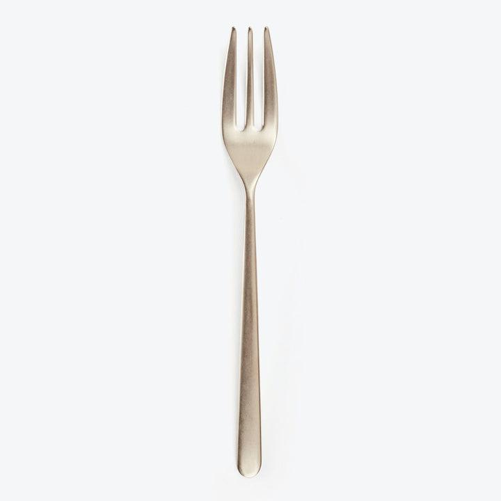 Single stainless steel fork with three tines on white background