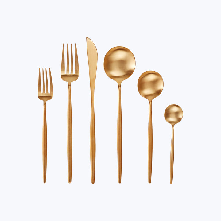 Set of six modern gold utensils for formal dining setting.