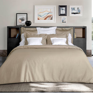 Folded cotton duvet cover in pale beige, neatly arranged fabric. - hover