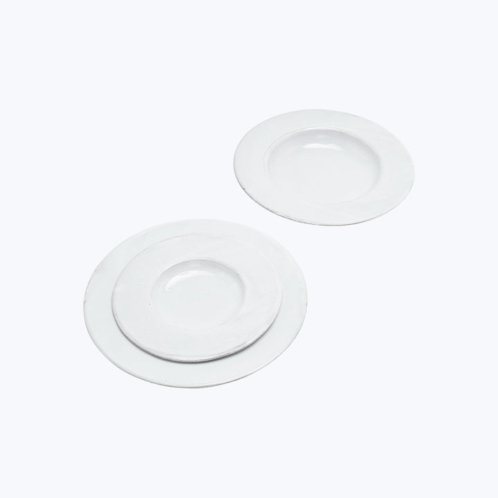 Two white ceramic plates on white background with shadows.