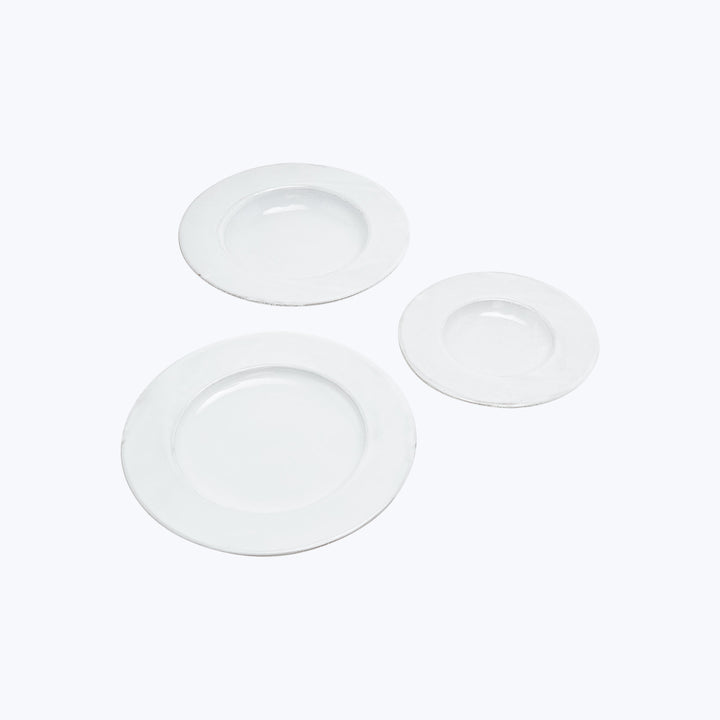 Minimalistic composition of three white plates on white background.