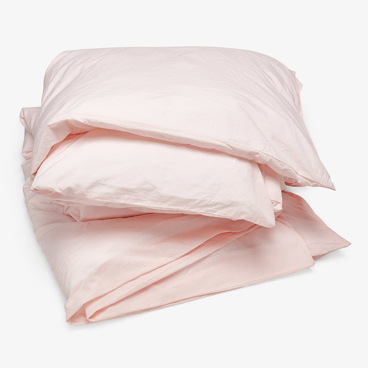 Soft pink bed linen set creates a calming and inviting atmosphere.