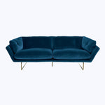 Modern blue velvet sofa with sleek design and metallic legs.