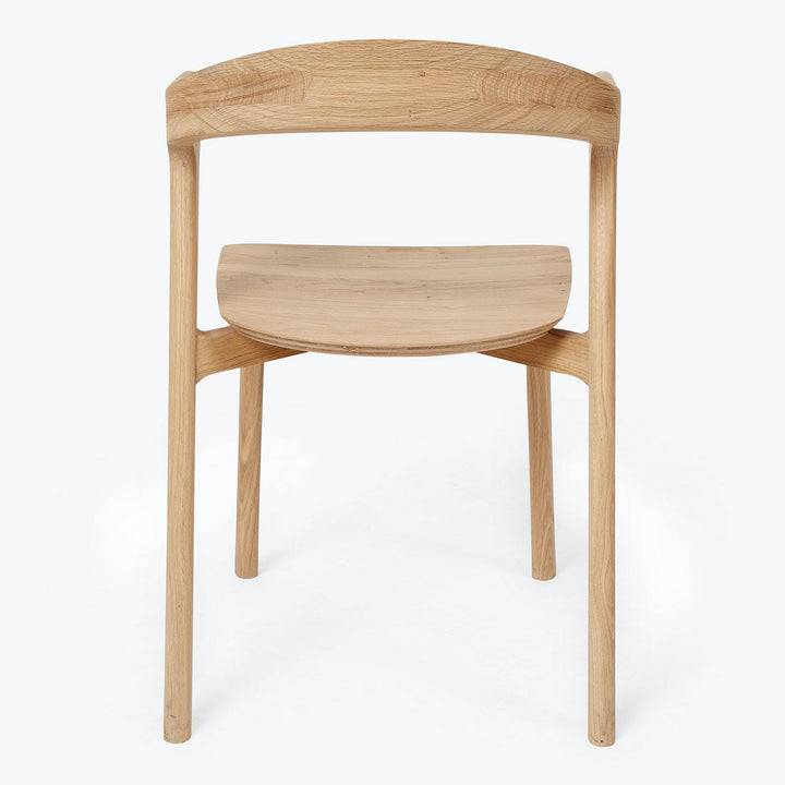 Minimalist wooden chair with ergonomic design, suitable for modern spaces.