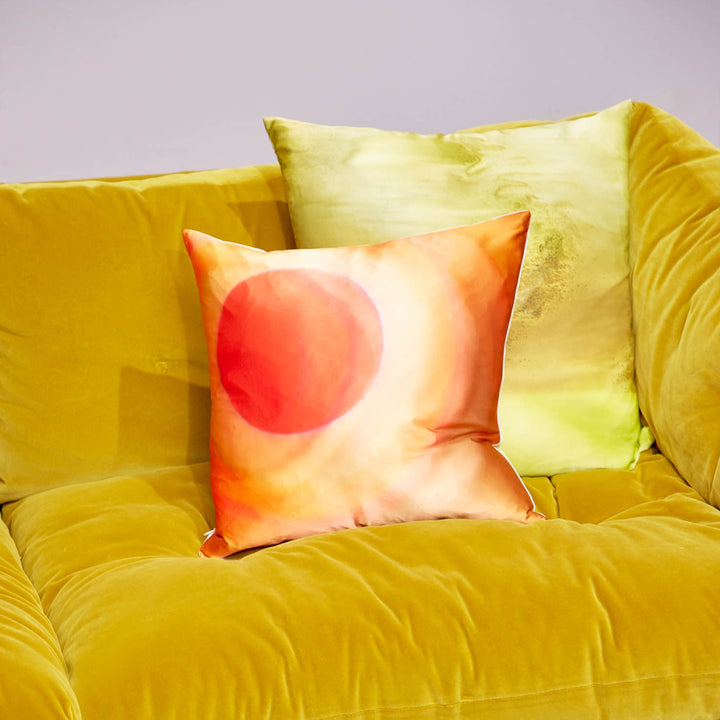 Yellow velvet sofa with artistic pillows in vibrant, cozy setting
