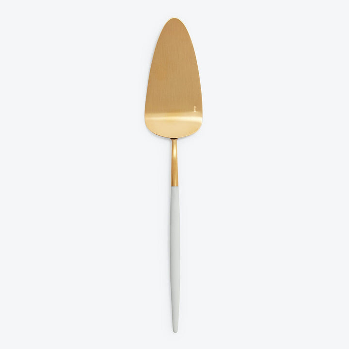 Elegant gold cake server with white handle for special occasions.