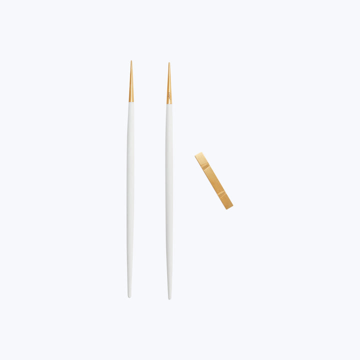 Two white knitting needles and one crochet hook on white