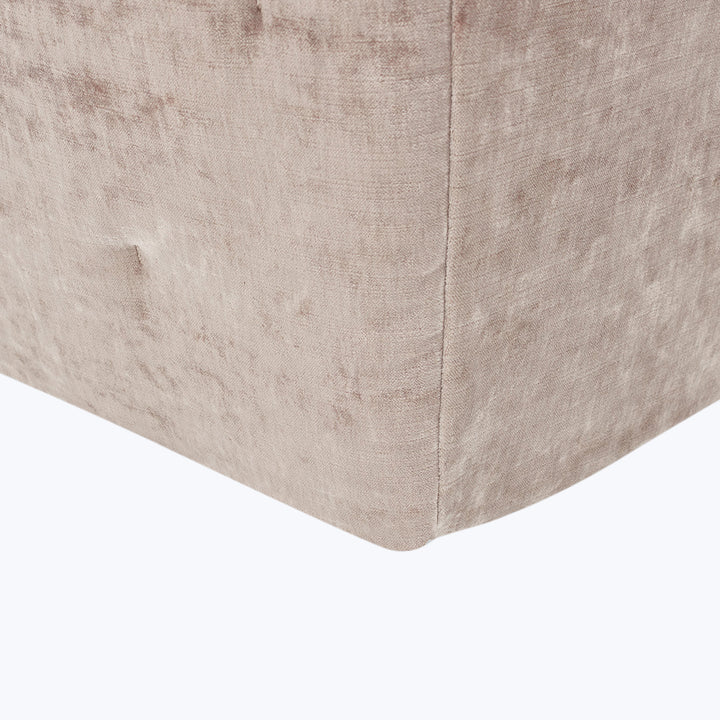 Close-up of well-crafted upholstered furniture corner in light beige fabric.