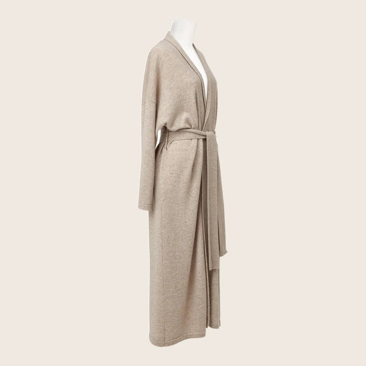 Beige cardigan with shawl collar and belt on mannequin display.