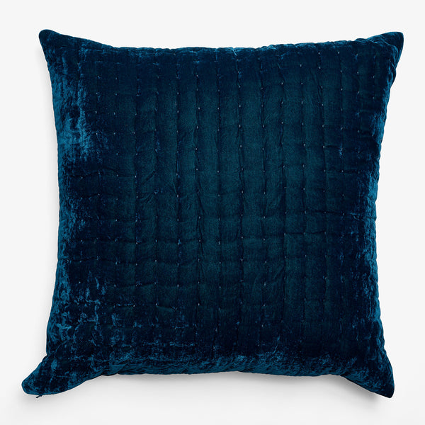 Rich blue plush pillow with ribbed velvet texture on white