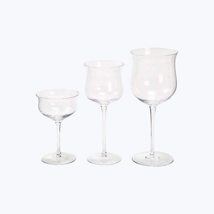 Three clear glass wine glasses, varying in size for wines.