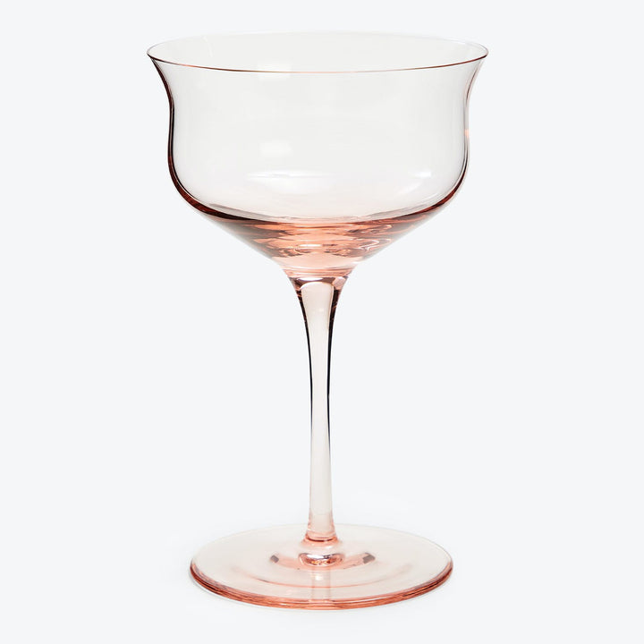 Empty wine glass with pink hue and traditional design.
