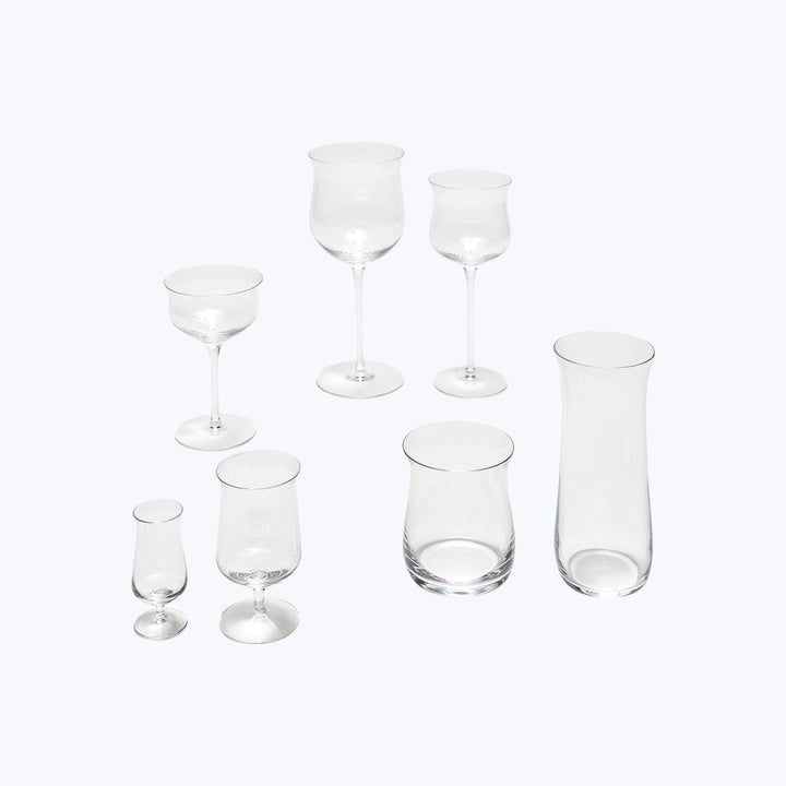 Collection of various glassware for different beverages on white background