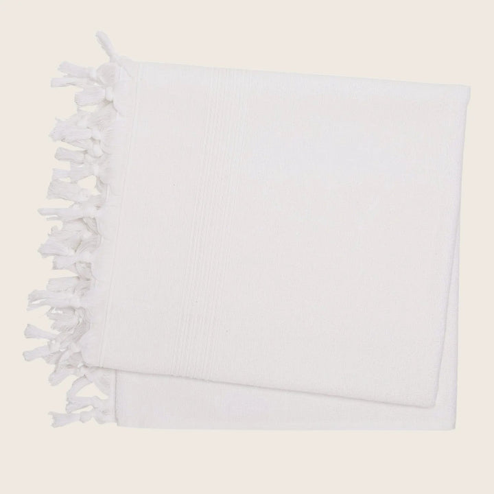 White textile item with knotted fringe detail on edge design