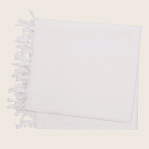 White textile item with knotted fringe detail on edge design