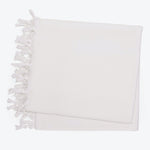White textile item with knotted fringe detail on edge design
