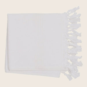White textile with fringe, texture, and parallel lines for decor.