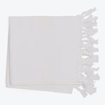 White textile with fringe, texture, and parallel lines for decor.