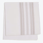 Neatly folded cloth with vertical stripe pattern on white background.