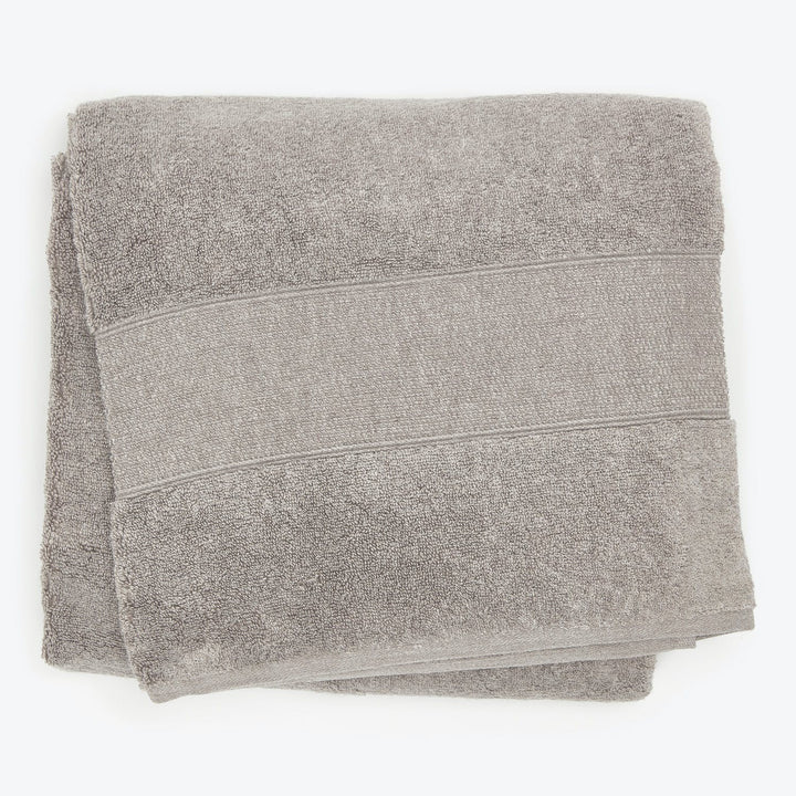 Soft gray bath towel with horizontal bands, plush texture, absorbent fabric.