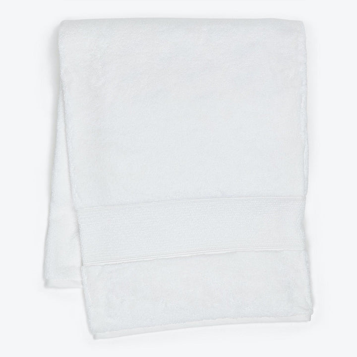 Soft white bath towel with ribbed strip for decoration and function.